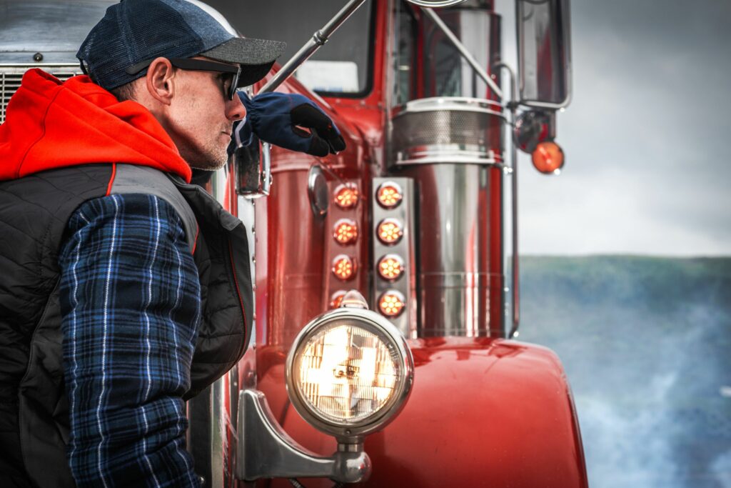 Colorado trucker standing in front of a red truck