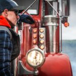 Colorado trucker standing in front of a red truck